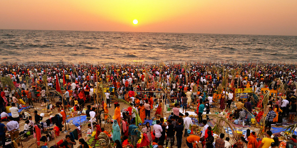 Devotees offering prayers at sunrise during Chhath Puja